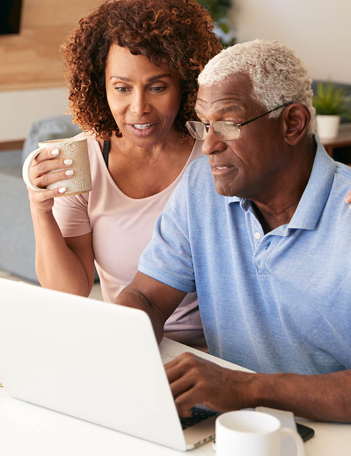 Electronic Statements man and woman looking at something on laptop