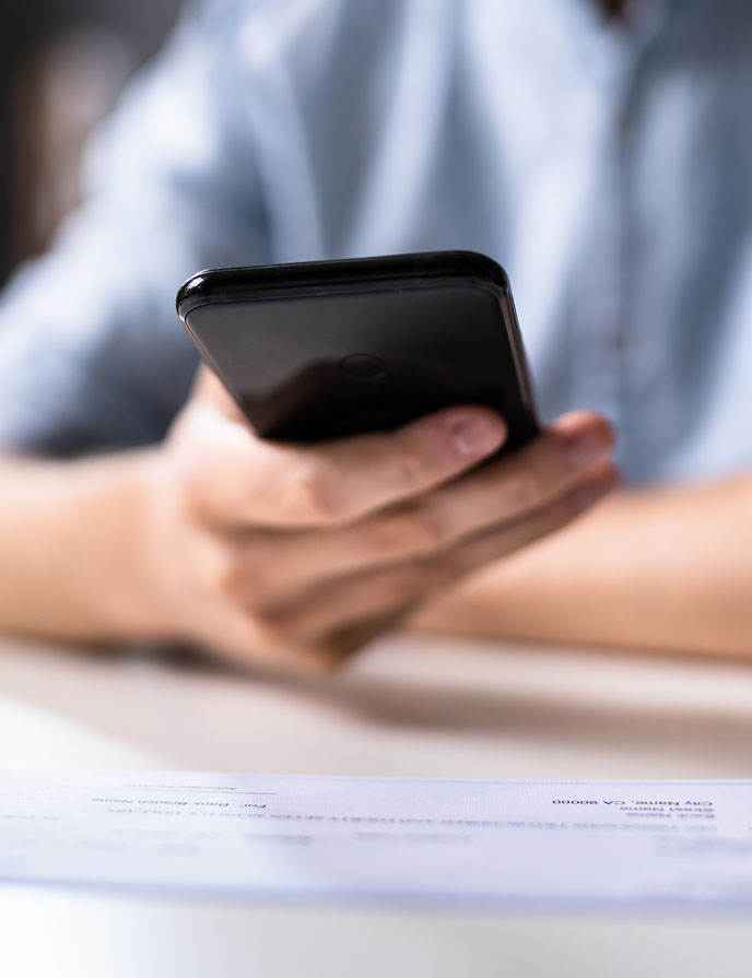 MSCU Mobile Deposits person's hand holding a cell phone