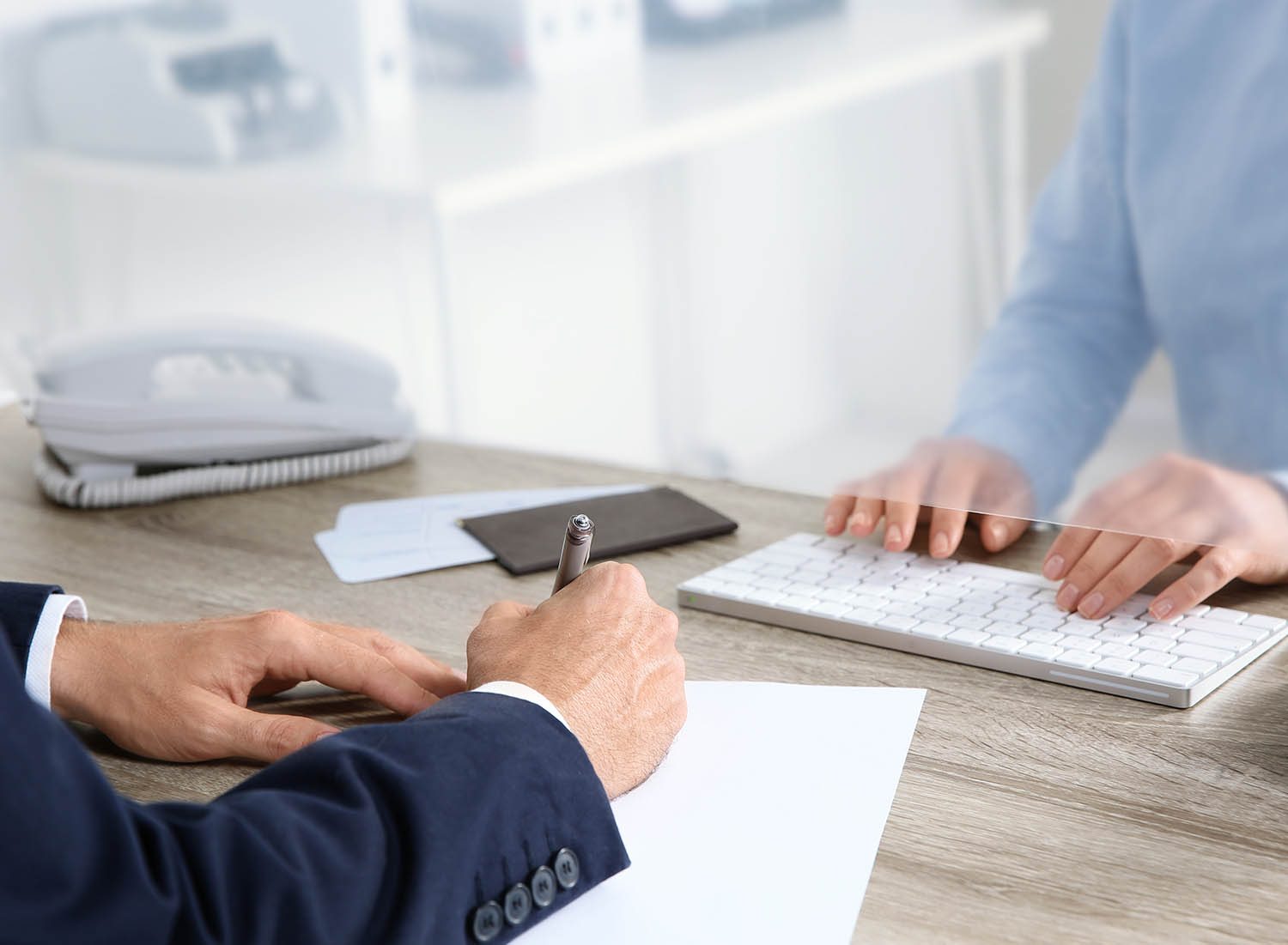 Mutual Savings Careers image of a person signing documents at a teller station