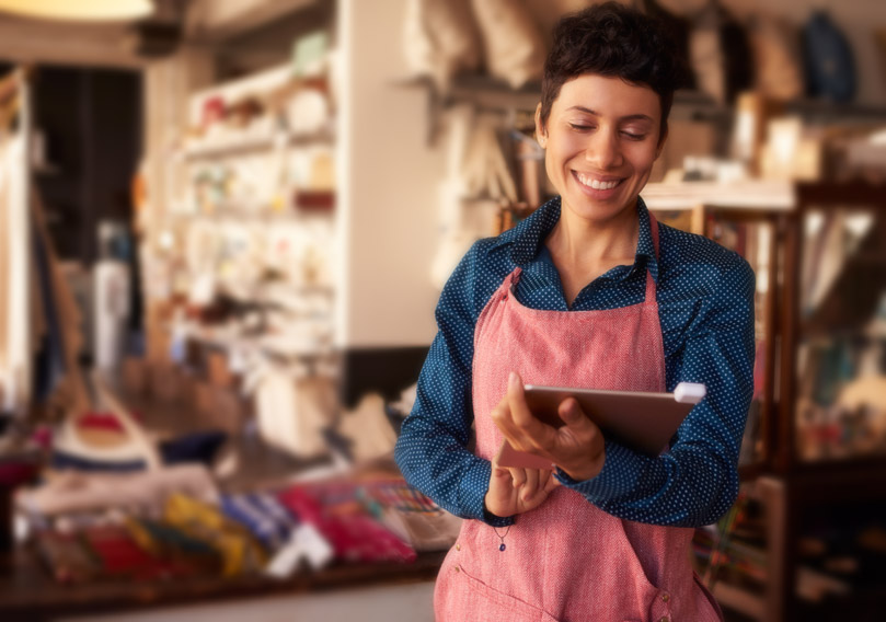 Right Choice Right Rate woman in apron working on laptop