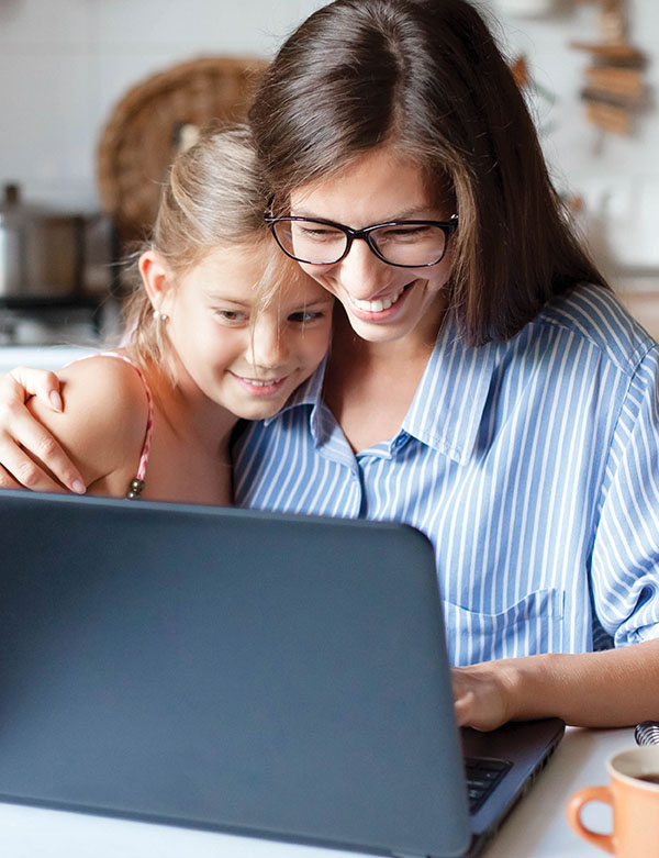 Who is Mutual Savings Credit Union woman and daughter looking at laptop screen