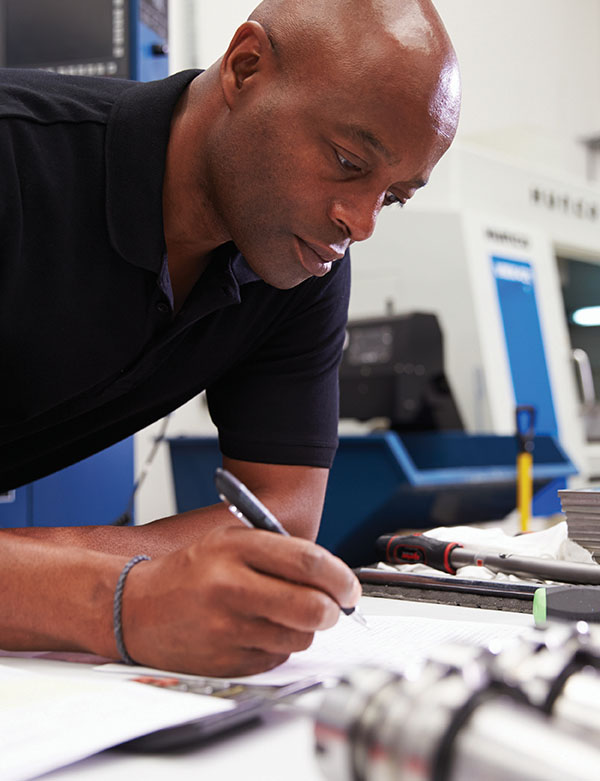 Why Mutual Savings Credit Union man writing notes on legal pad