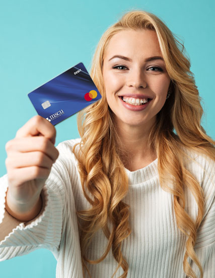 Girl holding Mutual Savings Credit Union debit card