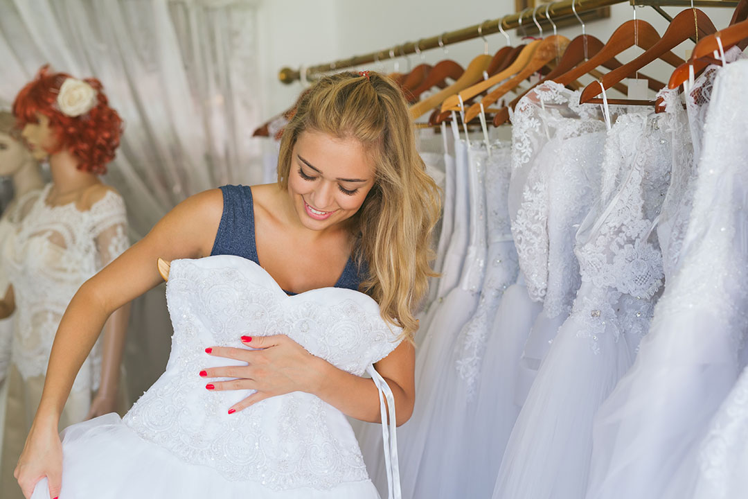 Woman,Choosing,Wedding,Dress,In,Shop